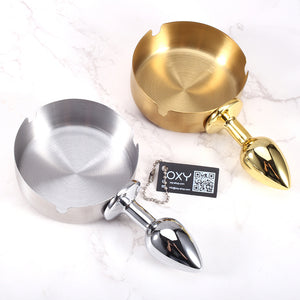 Dual-colored anal plug with a shiny chrome tip and a round ashtray-style bowl in silver and gold tones.