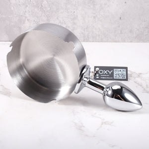 Cheeky anal plug with an ashtray-style top, featuring a sleek metallic finish and stable base for BDSM roleplay.