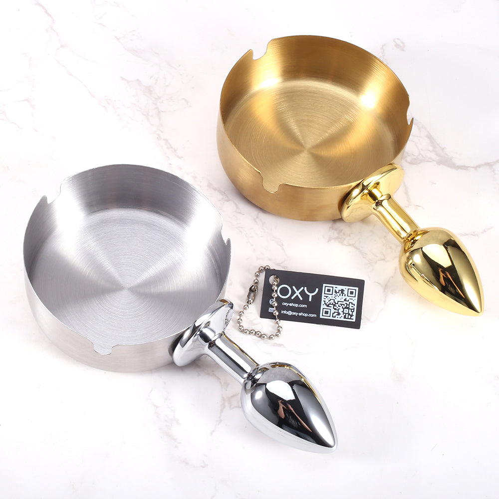 Dual-colored anal plug with a shiny chrome tip and a round ashtray-style bowl in silver and gold tones.